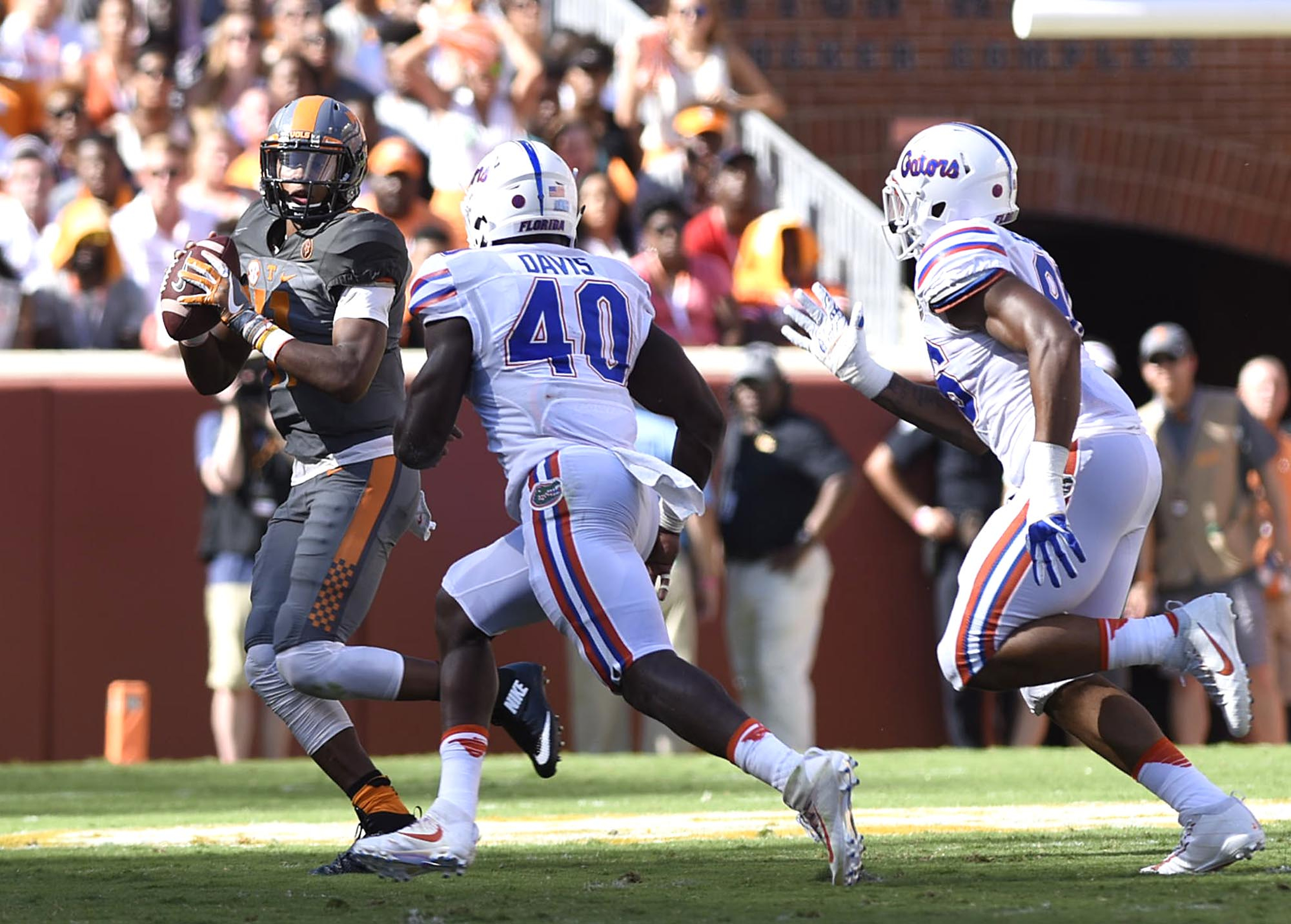 Tennessee's Joshua Dobbs (11) looks to pass while be hurried by the Gator defense. The Florida Gators visited the Tennessee Volunteers in a important SEC football contest at Neyland Stadium on September 24, 2016.