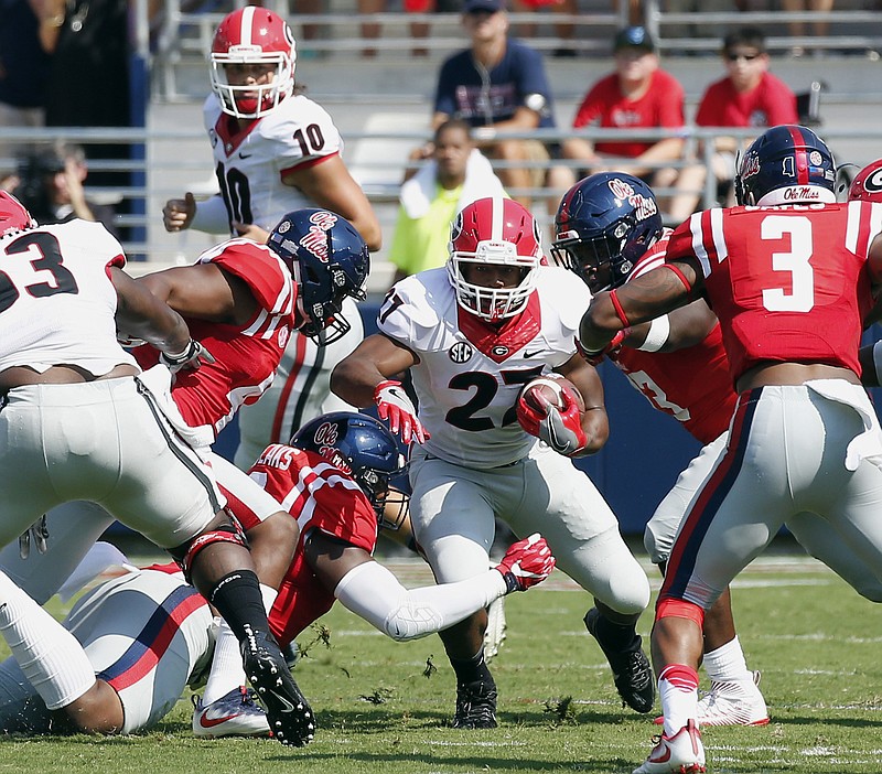 Georgia running back Nick Chubb (27) runs against Mississippi in the first half of their NCAA college football game, Saturday, Sept. 24, 2016, in Oxford, Miss. No. 23 Mississippi won 45-14. (AP Photo/Rogelio V. Solis)