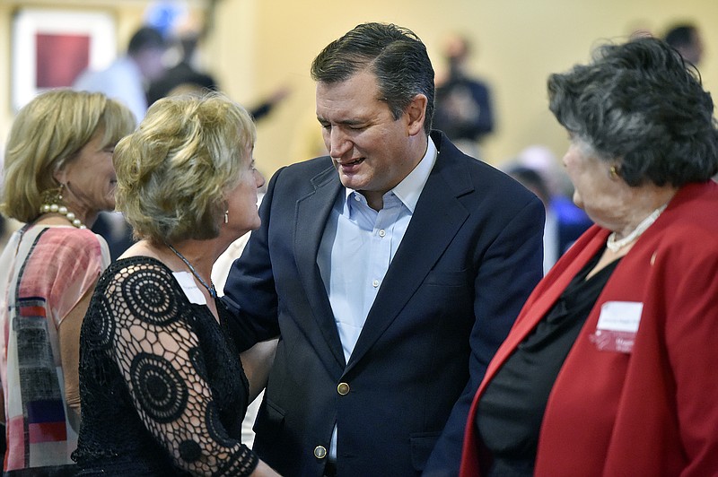 
              Sen. Ted Cruz, R-Texas, center, talks with Cathie Adams, past president of Texas Eagle Forum, at the annual Grassroots America We The People Champions of Freedom award dinner Friday, Sept. 23, 2016 in Tyler, Texas. Ted Cruz announced Friday he will vote for Donald Trump, a dramatic about-face that may help unite a deeply divided Republican Party months after the fiery Texas conservative called Trump a "pathological liar" and "utterly amoral." (Andrew D. Brosig/Tyler Morning Telegraph via AP)
            