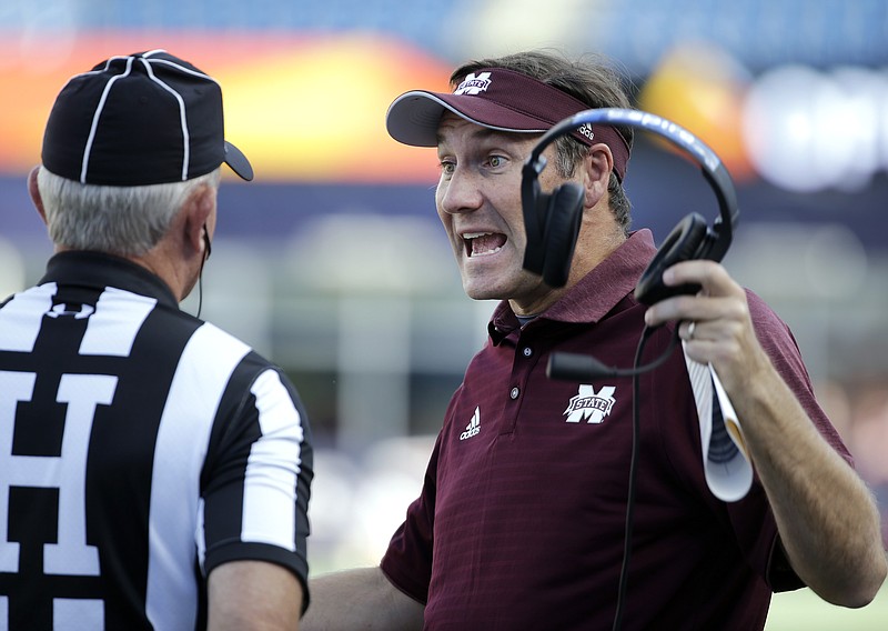Mississippi State head coach Dan Mullen speaks to the referee during the first half of an NCAA football game against Massachusetts, Saturday, Sept. 24, 2016, in Foxborough, Mass. (AP Photo/Elise Amendola)