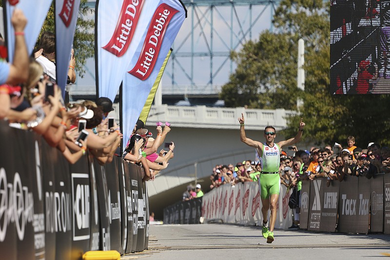 Staff Photo by Dan Henry / The Chattanooga Times Free Press- 9/25/16. Marino Vanhoenacker #2, from Jabbeke, BEL, raises his hands in victory as he wins the 2016 Little Debbie IRONMAN Chattanooga triathlon on September 25, 2016. Vanhoenacker won overall with a time of 8:12:22. More than 2,700 athletes registered to compete in a 2.4-mile swim, 116-mile bike and 26.2-mile run throughout Chattanooga and North Georgia. 