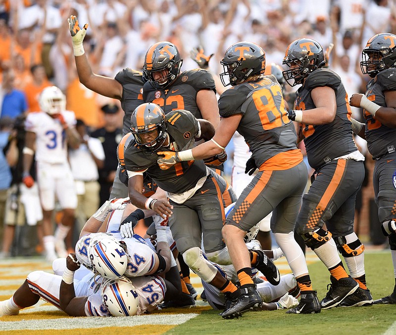 Tennessee quarteback Joshua Dobbs, center, comes up from the pile after scoring Tennessee's final touchdown in Saturday's comeback win against Florida in Knoxville.
