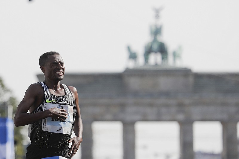 
              Ethiopia's Kenenisa Bekele crosses the finish to win the 43rd Berlin Marathon in Berlin, Germany, Sunday, Sept. 25, 2016. (AP Photo/Markus Schreiber)
            