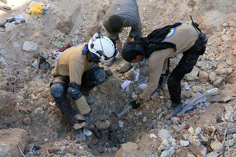 
              In this photo provided by the Syrian Civil Defense group known as the White Helmets, shows members of Civil Defense removing a dead body from under the rubble after airstrikes hit in Aleppo, Syria, Saturday, Sept. 24, 2016. Syrian government forces captured a rebel-held area on the edge of Aleppo on Saturday, tightening their siege on opposition-held neighborhoods in the northern city as an ongoing wave of airstrikes destroyed more buildings. (Syrian Civil Defense White Helmets via AP)
            