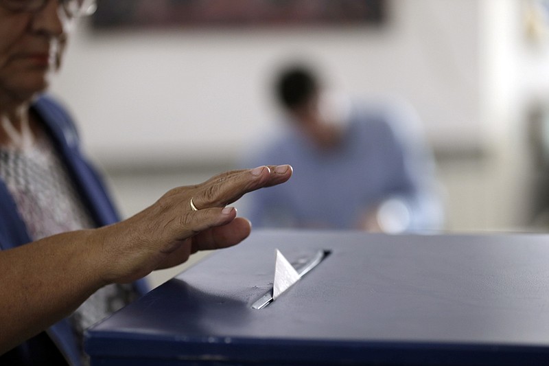 
              A Bosnian Serb woman casts his ballot at a poling station during referendum in the Bosnian town of Laktasi, northwest of the Bosnian capital of Sarajevo, Bosnia, Sunday, Sept. 25, 2016. Bosnian Serbs are voting in a referendum banned by the country's constitutional court, risking Western sanctions against their autonomous region and criminal charges against their leaders. (AP Photo/Amel Emric)
            