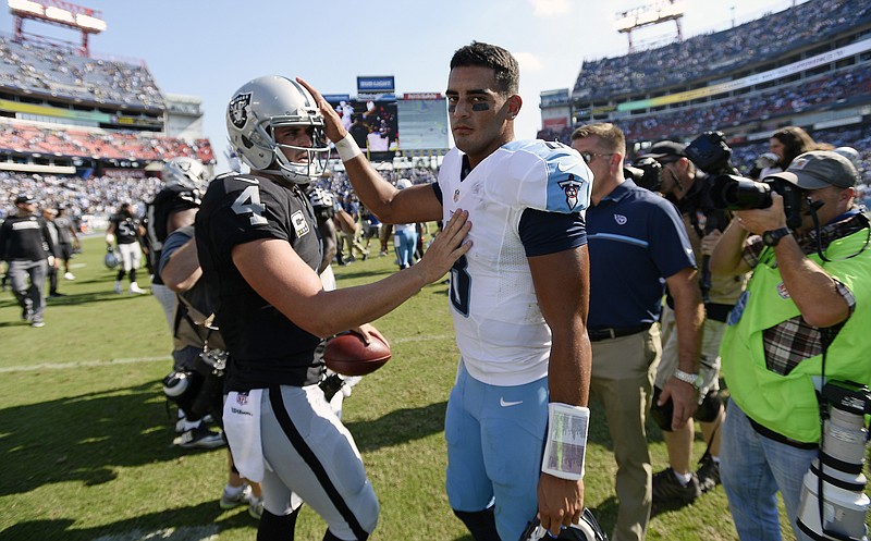 Oakland Raiders quarterback Derek Carr (4) meets with Tennessee Titans quarterback Marcus Mariota (8) after the Raiders beat the Titans 17-10 in an NFL football game Sunday, Sept. 25, 2016, in Nashville, Tenn. (AP Photo/Mark Zaleski)