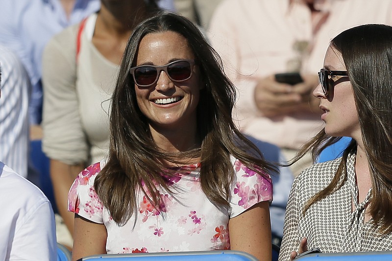 
              FILE- In this Friday, June 19, 2015 file photo, Pippa Middleton, left, the sister of Kate, the Duchess of Cambridge, watches the quarterfinal tennis match between Canada's Milos Raonic and France's Gilles Simon on the fifth day of the Queen's Championships in London. London police said Saturday, Sept. 24, 2016, they are investigating the reported hacking of the iCloud account of Pippa Middleton, younger sister of Catherine, Duchess of Cambridge. (AP Photo/Tim Ireland, File)
            