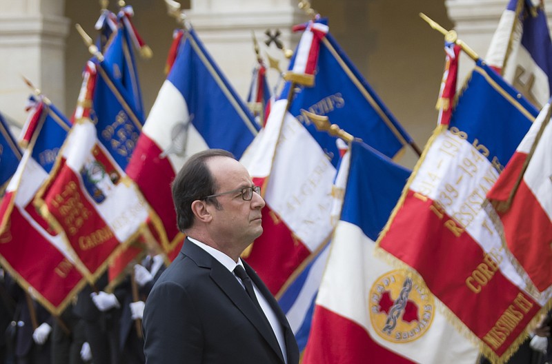 
              French president Francois Hollande stands to attention during a ceremony in which he acknowledged the state's responsibility in abandoning Algerians who fought alongside French colonial forces in Algeria's war for independence, in Paris, Sunday, Sept. 25, 2016. Tens of thousands of the fighters, known as harkis, were killed after the French withdrawal, and those who made it to France were placed in camps. (Ian Langsdon/Pool Photo via AP)
            