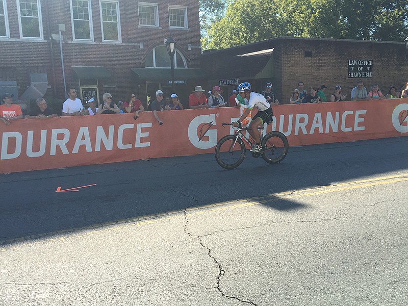 A cyclist rides through downtown Chickamauga Sunday morning during Ironman Chattanooga.