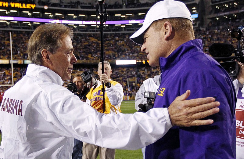 Alabama football coach Nick Saban, left, greets then-LSU coach Les Miles before their SEC West matchup in November 2014 in Baton Rouge, La. Miles was fired Sunday, and Saban talked Monday about the respect he has for him.