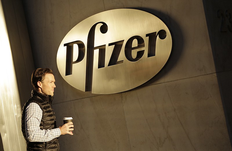 
              FILE - In this Monday, Nov. 23, 2015, file photo, a man enters Pfizer's world headquarters, in New York. Pfizer will not split into two publicly traded companies, a decision that, at least for now, ends Wall Street speculation over the drugmaker's future. The company believes it is best positioned to maximize shareholder value in its current form, but said Monday, Sept. 26, 2016, that it's reserving the right to split in the future if the situation changes. (AP Photo/Mark Lennihan, File)
            