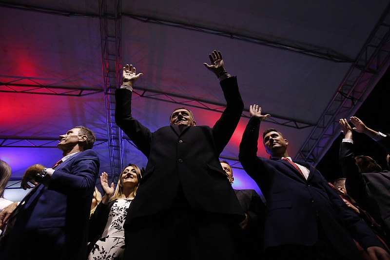 
              Bosnian Serb Milorad Dodik, President of the Bosnian Serb region of Republic of Srpska, greets supporters during celebrations after the result of the referendum in the Bosnian town of Pale, Bosnia, on Sunday Sept. 25, 2016. Sunday's vote asks residents of Republika Srpska whether to maintain a national holiday on Jan. 9, despite a ruling of Bosnia's constitutional court that the date discriminates against non-Serbs. (AP Photo/Amel Emric)
            