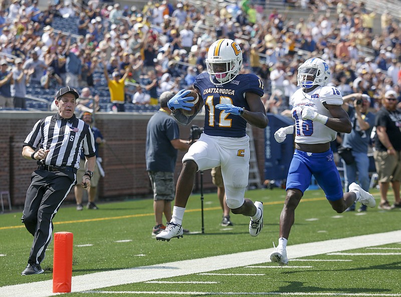 UTC wide receiver Xavier Borishade (12) crosses intot he end zone for a touchdown ahead of Presbyterian defensive back Rock Ya-Sin during the Mocs' home football game against Presbyterian at Finley Stadium on Saturday, Sept. 10, 2016, in Chattanooga, Tenn.