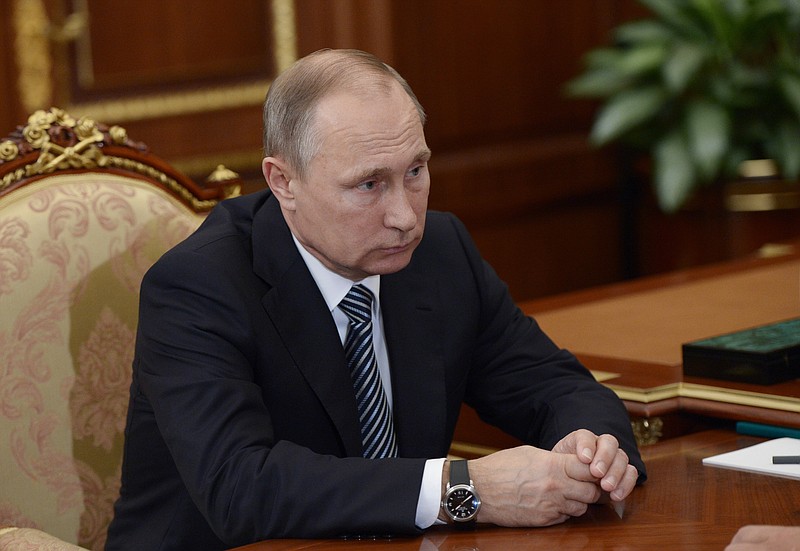 
              Russian President Vladimir Putin listens during a meeting with VTB CEP Andrei Kostin in Moscow's Kremlin on Tuesday, Sept. 27, 2016. The meeting focused on the current operations of the state-controlled VTB, Russia's second-largest bank. (Alexei Nikolsky/Sputnik, Kremlin Pool Photo via AP)
            