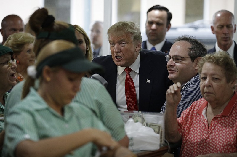 
              Republican presidential candidate Donald Trump visits a restaurant, Tuesday, Sept. 27, 2016, in Miami. (AP Photo/John Locher)
            