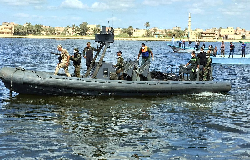 
              Egyptian coast guard and rescue workers bring ashore bodies recovered from a Europe-bound boat that capsized off Egypt's Mediterranean coast last week, in Rosetta, Egypt, Tuesday, Sept. 27, 2016 . Dozens of bodies were pulled from the hold of the Mawkib al-Rasoul, or "Procession of the Prophet," the Egyptian fishing boat that sank carrying hundreds of migrants, bringing the toll from the disaster to more than 200 dead. Families of those missing gathered at a pier outside the coastal city of Rosetta as the dead were brought to shore, and relatives went through the grisly task of searching through the body bags for their loved ones. (AP Photo/Maggie Michael)
            