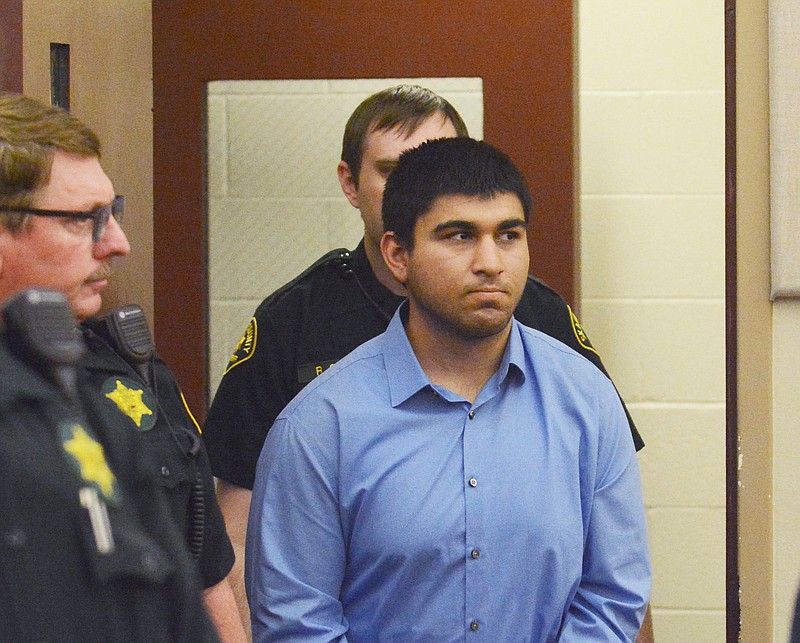 
              Arcan Cetin is escorted into Skagit County District Court by Skagit County's Sheriff's Deputies on Monday, Sept. 26, 2016. Cetin is being held under a magistrate's warrant which will give Skagit County prosecutors 30 days to file charges in relation to the Cascade Mall shooting that took place on Friday evening. Five people were killed in the shooting, and Cetin is being held on a $2 million bail. (Brandy Shreve/Skagit Valley Herald via AP)
            