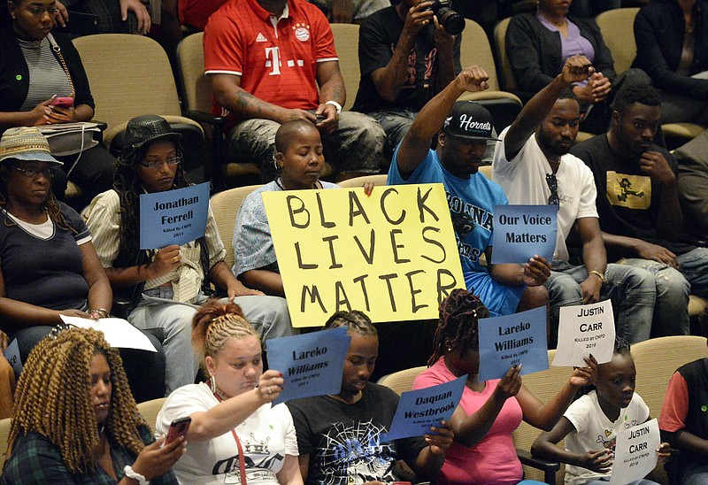 
              Audience members show support for speakers at the Charlotte City Council during time for public comments, mainly concerning last week's Scott shooting, at the Charlotte Mecklenburg Government Center on Monday, Sept. 26, 2016.   (David T. Foster III/The Charlotte Observer via AP)
            