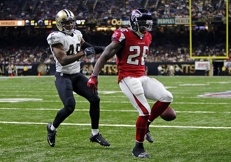 Atlanta Falcons running back Tevin Coleman (26) crosses into the end zone for a touchdown in front of New Orleans Saints free safety Vonn Bell (48) in the second half of an NFL football game in New Orleans, Monday, Sept. 26, 2016.