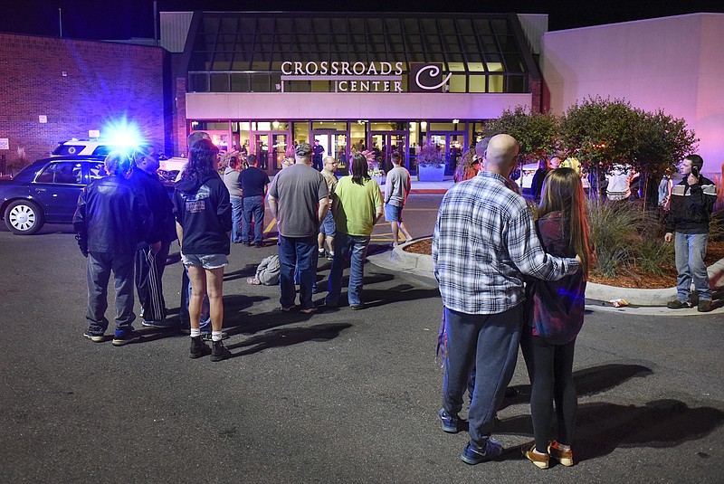 
              FILE - In this Sept. 17, 2016, file photo, people stand near an entrance of Crossroads Center shopping mall in St. Cloud, Minn., after several people were stabbed. FBI Director James Comey said Wednesday, Sept. 28, 2016, that the man who stabbed multiple people in the mall before being shot and killed appears to have been inspired, at least in part, by extremist ideology. (Dave Schwarz/St. Cloud Times via AP File)
            