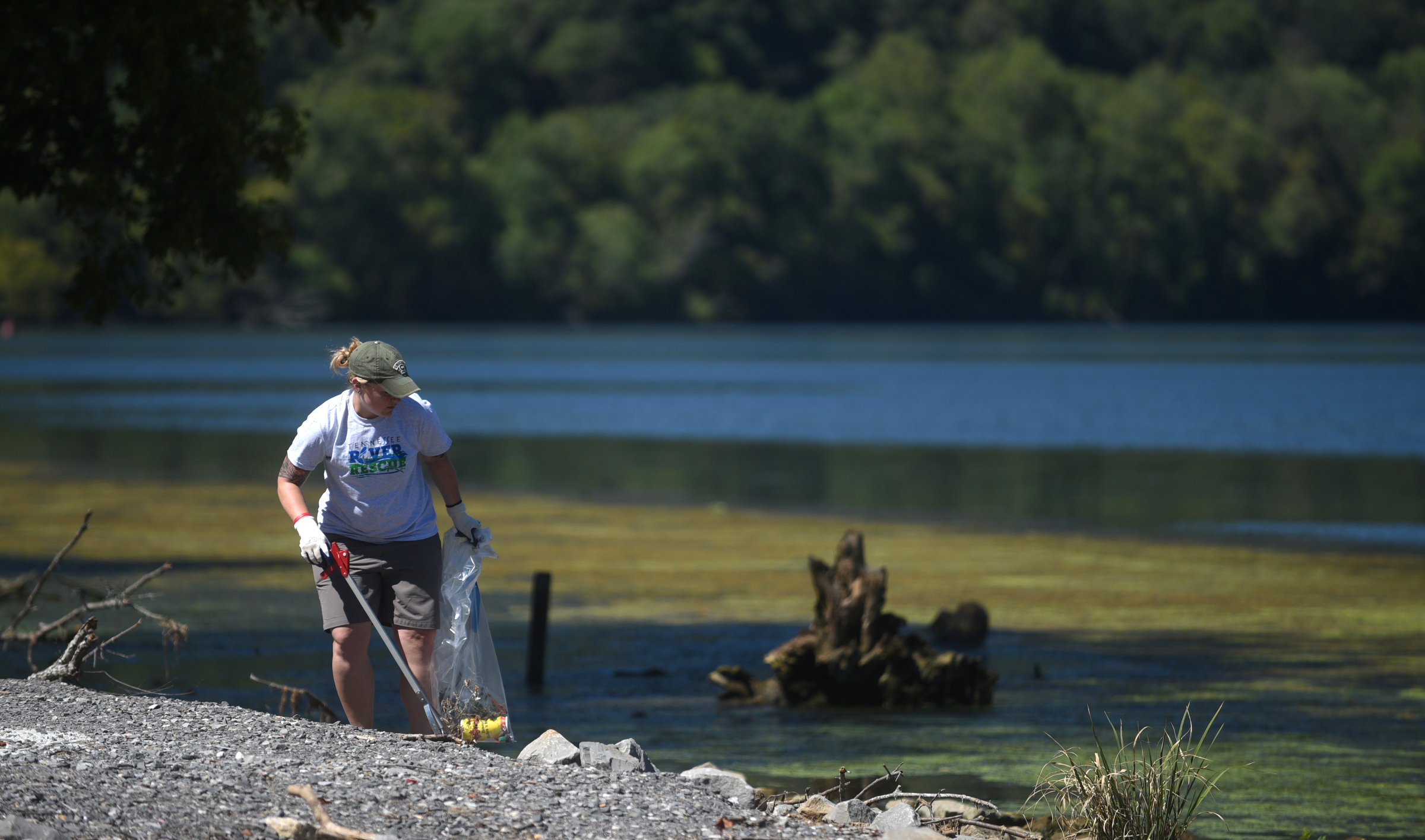 Tennessee Aquarium employee Valerie Bogie picks up trash Wednesday, Sept. 28, 2016 on the river bank in the Tennessee River Gorge in Marion County. Some Tennessee Aquarium and Clean Harbors staff members spent part of the afternoon on the water picking up trash in advance of the Tennessee River Rescue, which takes place Saturday.