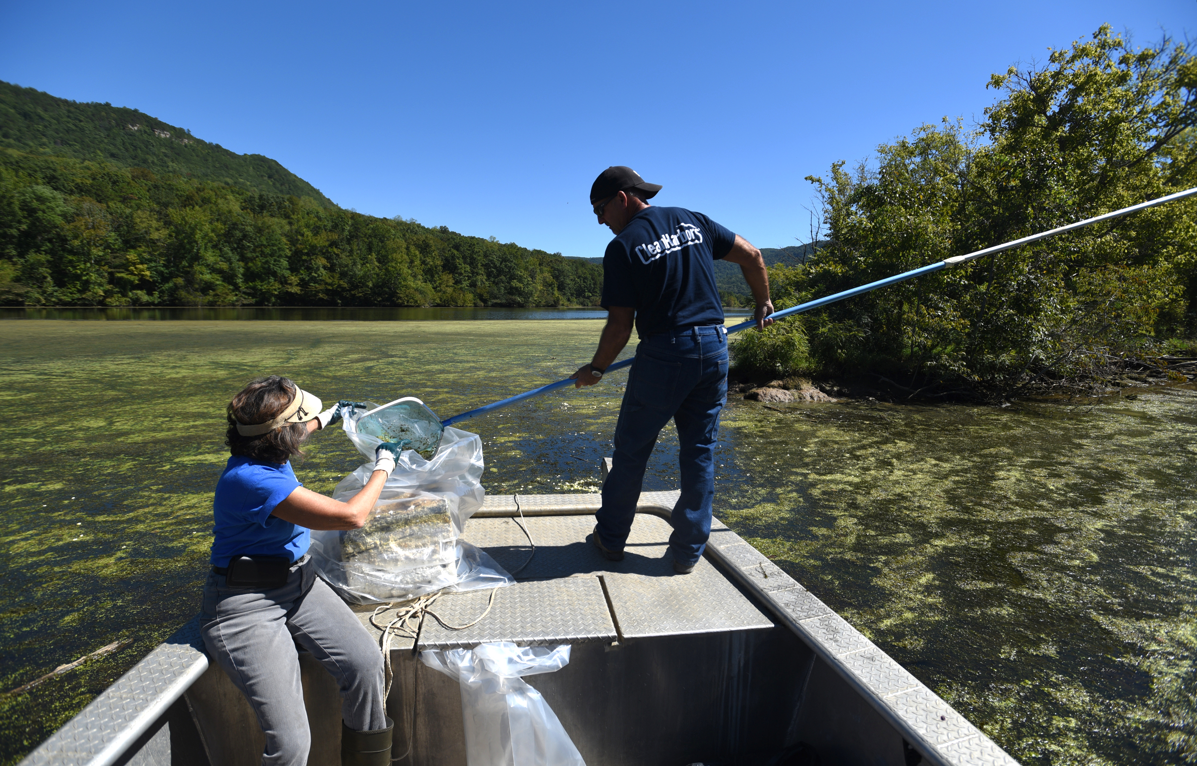 Christine Hunt and Gresh Tuggle, from left, bag trash from the river Wednesday, Sept. 28, 2016 in the Tennessee River Gorge in Marion County. Some Tennessee Aquarium and Clean Harbors staff members spent part of the afternoon on the water picking up trash in advance of the Tennessee River Rescue, which takes place Saturday.