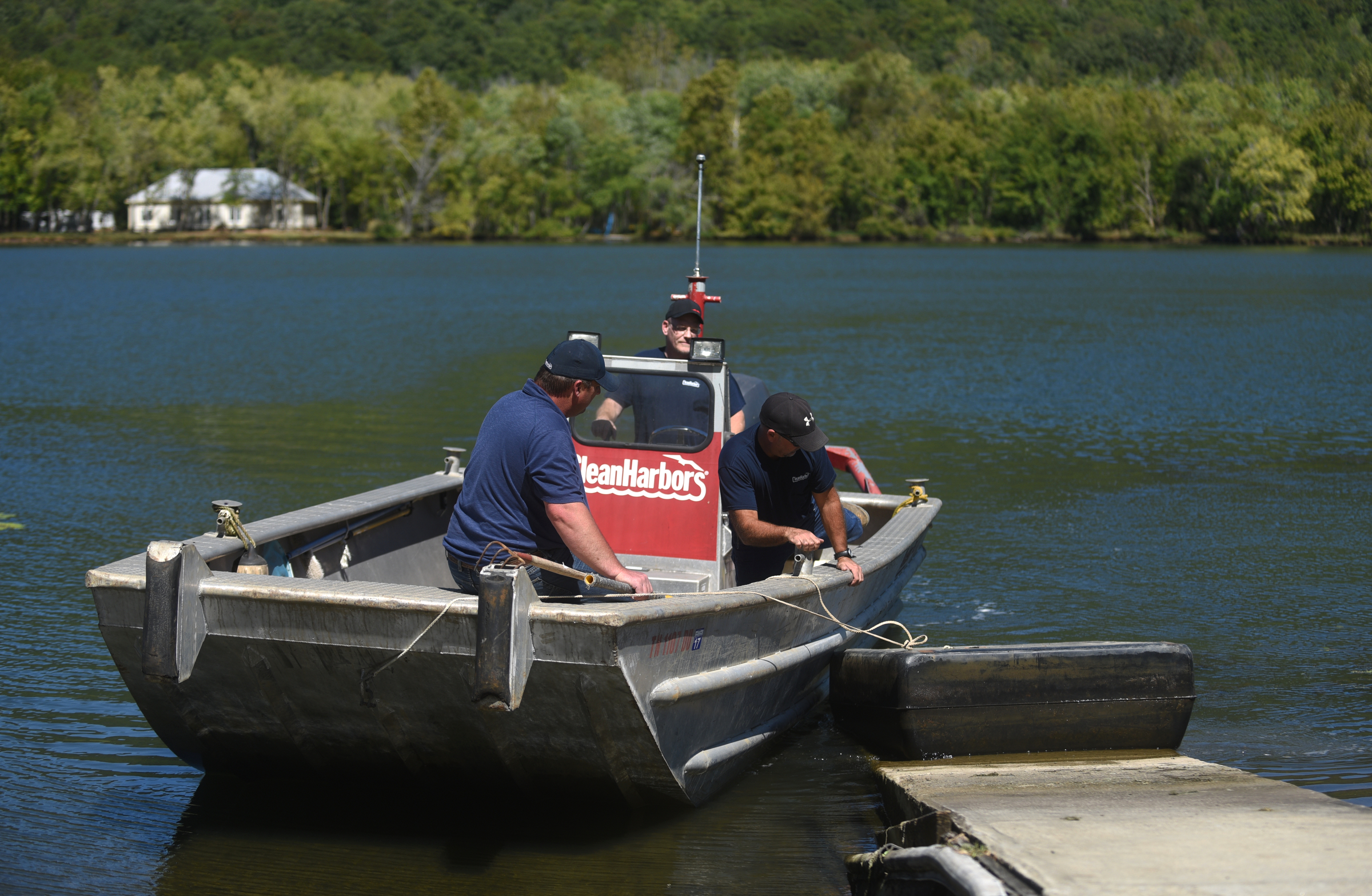 Danny Meadows, Eric Montgomery and Gresh Tuggle, from left, with Clean Harbors, bring a piece of a dock back into the ramp Wednesday, Sept. 28, 2016 in the Tennessee River Gorge in Marion County. Some Tennessee Aquarium and Clean Harbors staff members spent part of the afternoon on the water picking up trash in advance of the Tennessee River Rescue, which takes place Saturday.