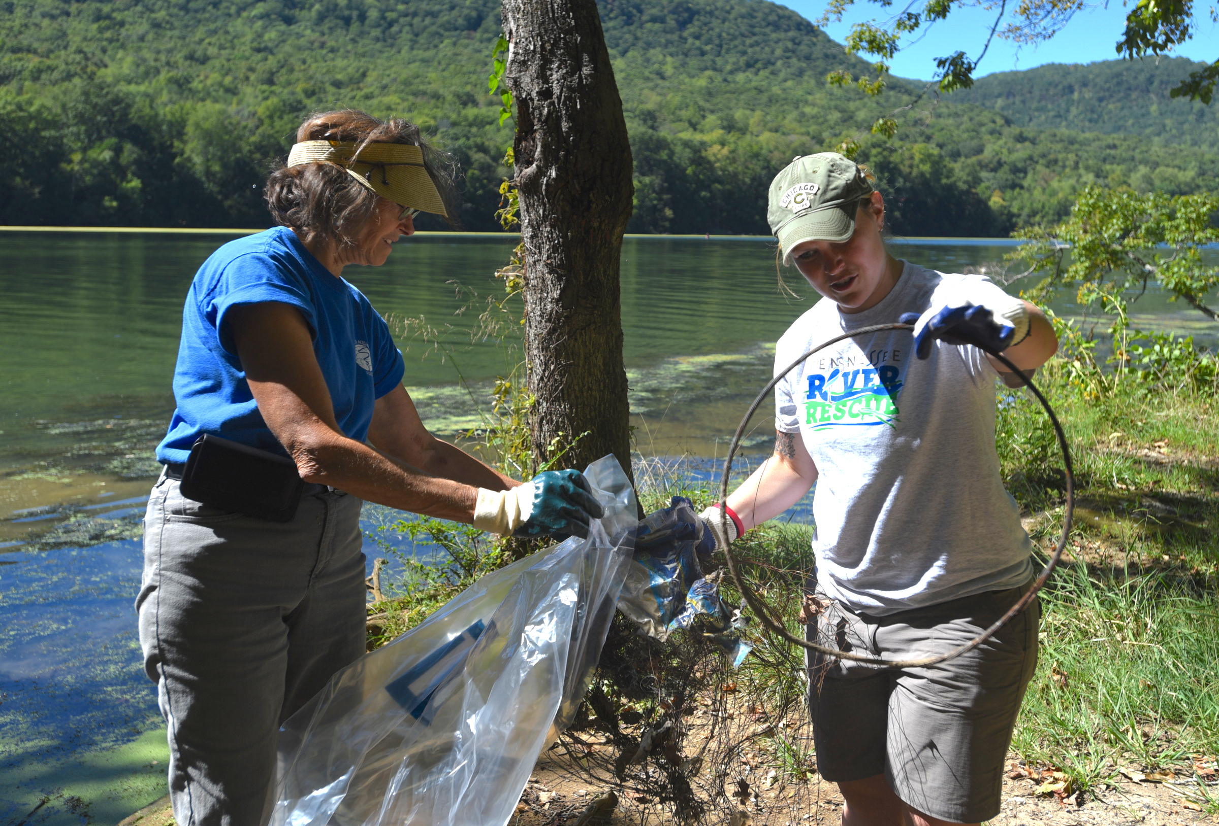 Tennessee Aquarium employees Christine Hunt, left, and Valerie Bogie bag trash on the shore Wednesday, Sept. 28, 2016 in the Tennessee River Gorge in Marion County. Some Tennessee Aquarium and Clean Harbors staff members spent part of the afternoon on the water picking up trash in advance of the Tennessee River Rescue, which takes place Saturday.