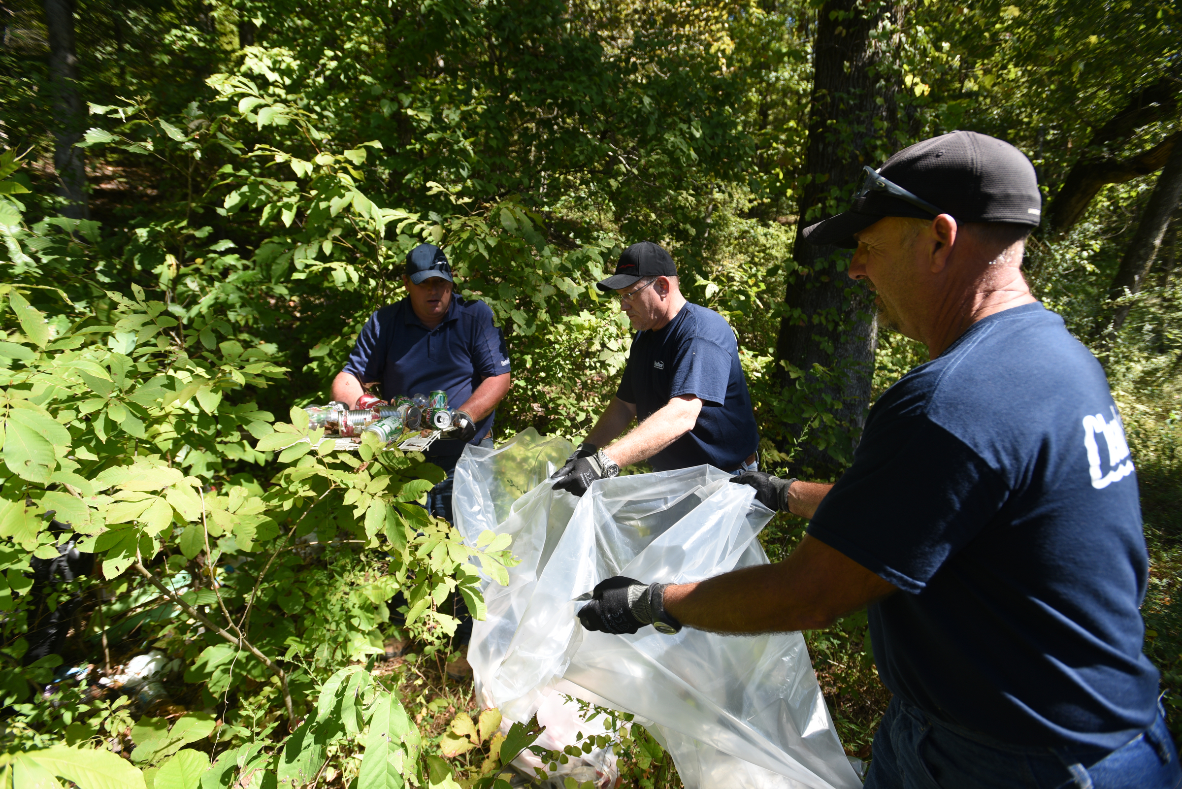 Danny Meadows, Eric Montgomery and Gresh Tuggle, from left, with Clean Harbors, bag trash on the river bank Wednesday, Sept. 28, 2016 in the Tennessee River Gorge in Marion County. Some Tennessee Aquarium and Clean Harbors staff members spent part of the afternoon on the water picking up trash in advance of the Tennessee River Rescue, which takes place Saturday.