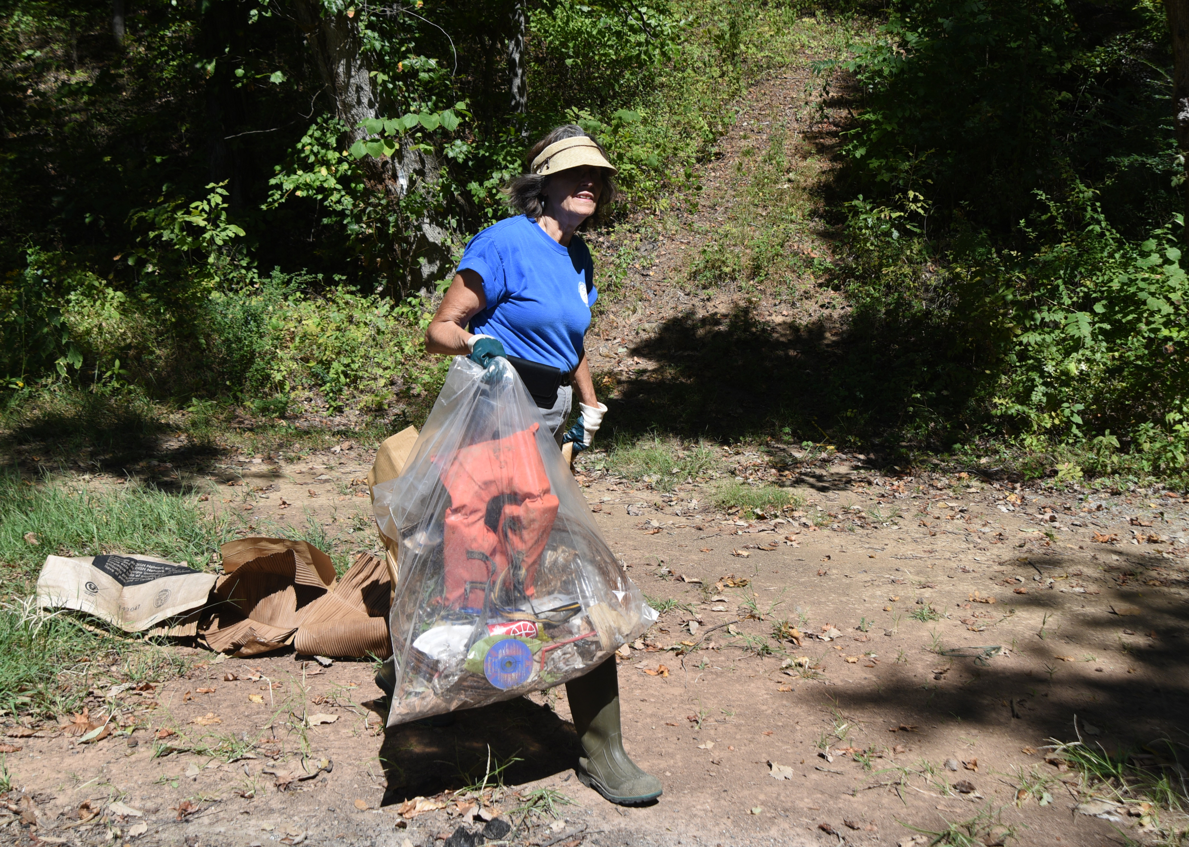 Tennessee Aquarium employee Christine Hunt carries trash back to the boat Wednesday, Sept. 28, 2016 in the Tennessee River Gorge in Marion County. Some Tennessee Aquarium and Clean Harbors staff members spent part of the afternoon on the water picking up trash in advance of the Tennessee River Rescue, which takes place Saturday.