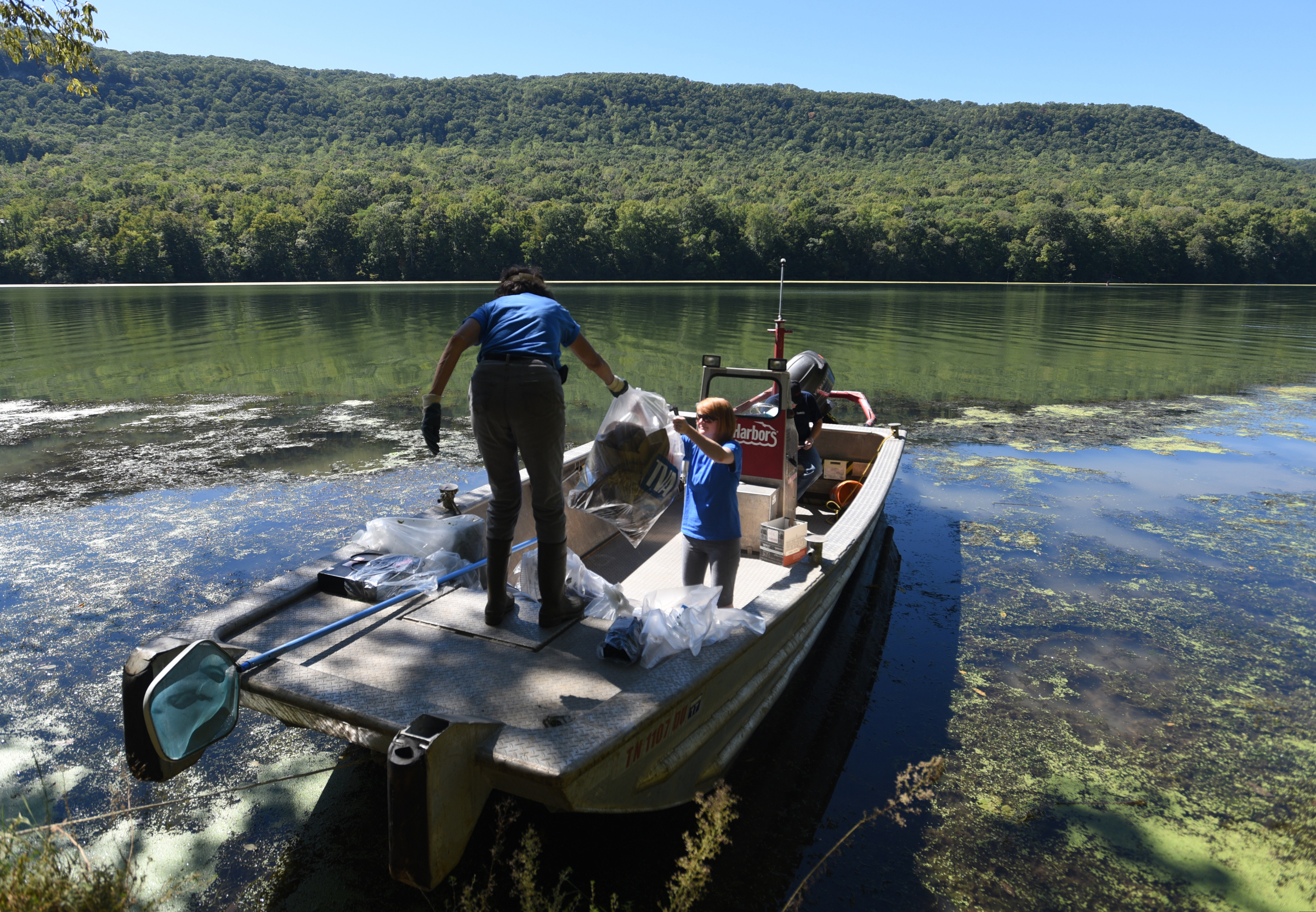 Tennessee Aquarium employees Christine Hunt, left, and Carrie Howell Shaw bring bagged trash back to the boat Wednesday, Sept. 28, 2016 in the Tennessee River Gorge in Marion County. Some Tennessee Aquarium and Clean Harbors staff members spent part of the afternoon on the water picking up trash in advance of the Tennessee River Rescue, which takes place Saturday.