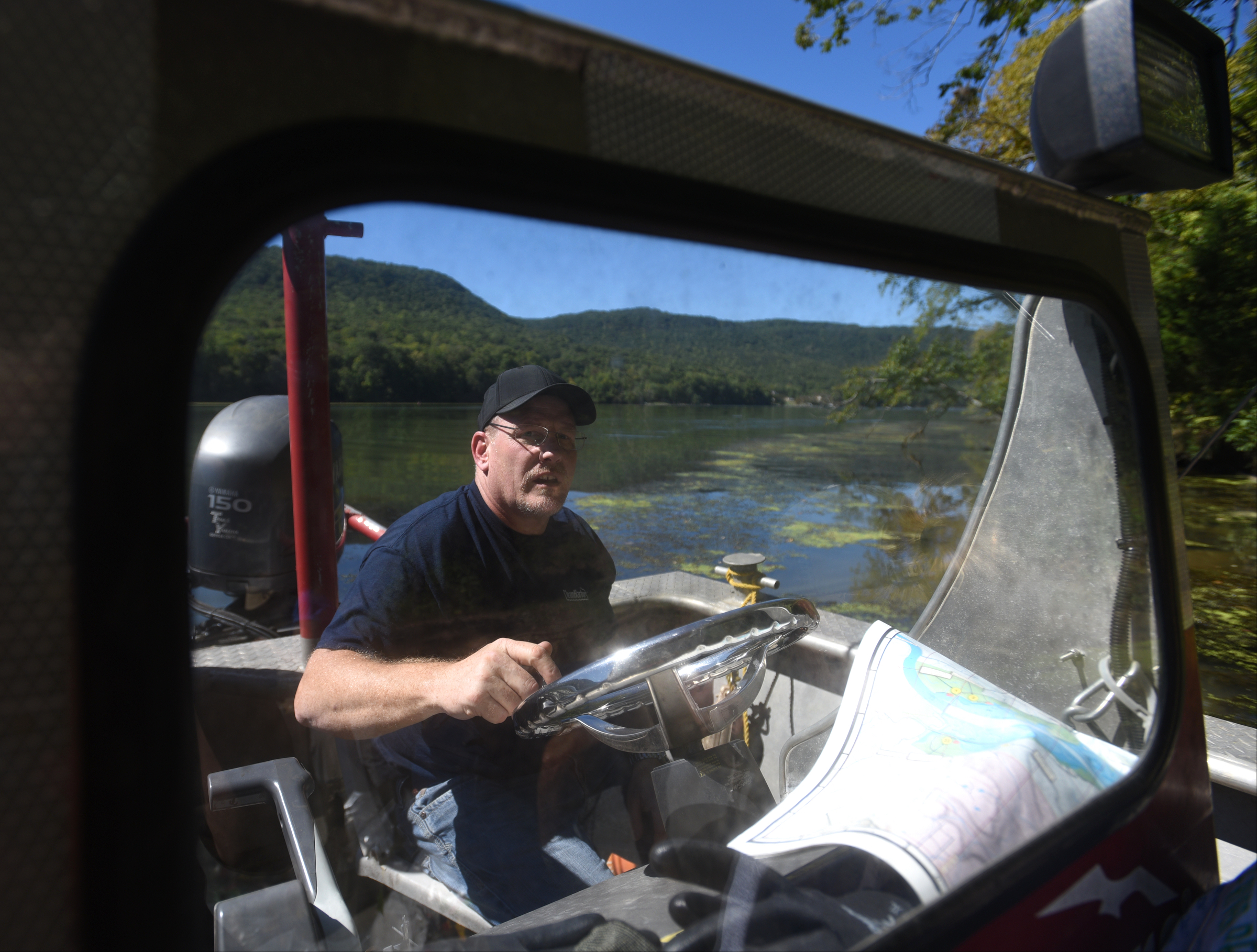Eric Montgomery , with Clean Harbors, drives the boat Wednesday, Sept. 28, 2016 in the Tennessee River Gorge in Marion County Wednesday, Sept. 28, 2016. Some Tennessee Aquarium and Clean Harbors staff members spent part of the afternoon on the water picking up trash in advance of the Tennessee River Rescue, which takes place Saturday.