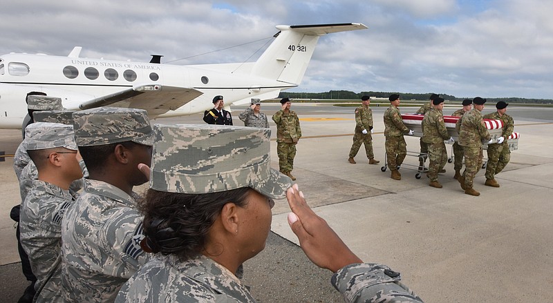 
              Members of the Army "Old Guard" unit escort remains thought to be those of U.S. troops who died in the Mexican-American War as they arrived at at Dover Air Force Base in Dover, Del., Wednesday, Sept. 28, 2016. The remains thought to be those of U.S. troops who died in the Mexican-American War have been flown to a military mortuary in Delaware in an effort to determine whether they belonged to militia members of a Tennessee regiment known as "The Bloody First." (Gary Emeigh/The Wilmington News-Journal via AP)
            