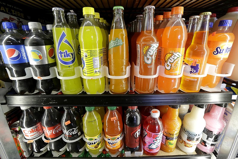 
              Soft drink and soda bottles are displayed in a refrigerator at El Ahorro market in San Francisco, Wednesday, Sept. 21, 2016. In November 2016, voters in San Francisco and Oakland will consider a penny per ounce tax on sugar laden drinks such as bottled cola, sports drinks and iced teas in November. (AP Photo/Jeff Chiu)
            