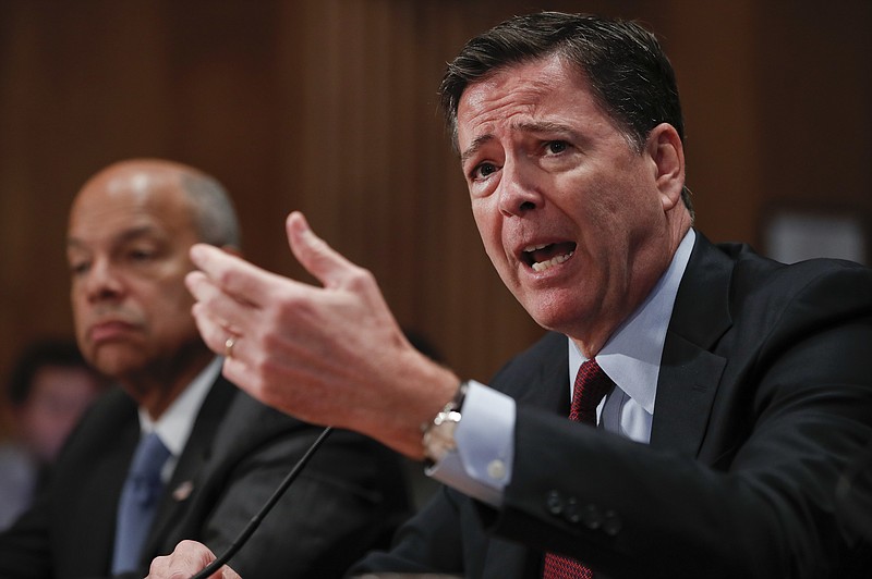 
              In this Sept. 27, 2016, photo, FBI Director James Comey, right, responds to a question while testifying on Capitol Hill in Washington. At left is Homeland Secretary Jeh Johnson. For the second time in two days, Comey will face questions from members of Congress about the agency’s response to recent acts of extremist violence and whether more could have been done to prevent attacks in Orlando and New York. (AP Photo/Pablo Martinez Monsivais)
            