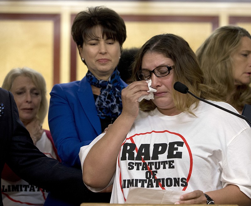 
              FILE - In this Sept. 6, 2016 file photo, Norma Hernandez wipes her eyes as she talks about being raped when she was 13, during a news conference in Sacramento, Calif. The emotional stories of women who say they were sexually assaulted more than a decade ago by comedian Bill Cosby prompted Wednesday, Sept. 28, California state lawmakers to approve a bill to eliminate the state's 10-year limit on filing rape and related charges. (AP Photo/Rich Pedroncelli, File)
            