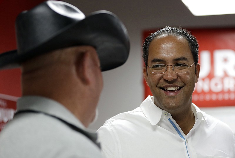 
              FILE - In this Aug. 27, 2016, file photo, first-term Republican Rep. Will Hurd, right, of Texas, talks with a supporter at a campaign office in San Antonio. Hurd faces former Democratic Rep. Pete Gallego in Texas' 23rd District, which spans 58,000-plus square miles, making it larger than 29 states. Neither Hurd nor Gallego live in the district. (AP Photo/Eric Gay, File)
            