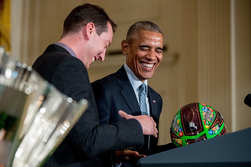 
              President Barack Obama shakes hands with Kyle Busch as he accepts a race car helmet as a gift during a ceremony in the East Room of the White House in Washington, Wednesday, Sept. 28, 2016, honoring the 2015 NASCAR Sprint Cup Series champions. (AP Photo/Andrew Harnik)
            