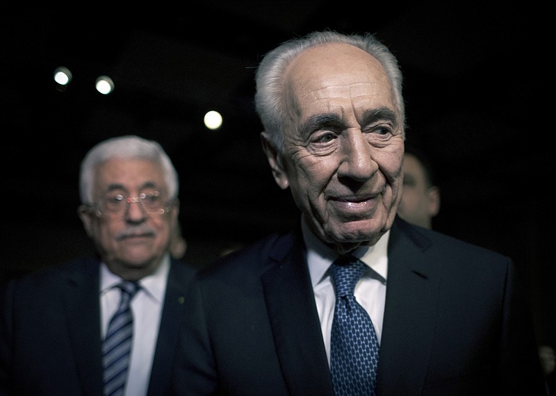 In this May 22, 2015, file photo, former Israeli President Shimon Peres, right, and Palestinian President Mahmoud Abbas arrive to attend the opening session of the World Economic Forum at the King Hussien convention center, Southern Shuneh, Jordan. Shimon Peres, a former Israeli president and prime minister, whose life story mirrored that of the Jewish state and who was celebrated around the world as a Nobel prize-winning visionary who pushed his country toward peace, has died, the Israeli news website YNet reported early Wednesday, Sept. 28, 2016. He was 93.