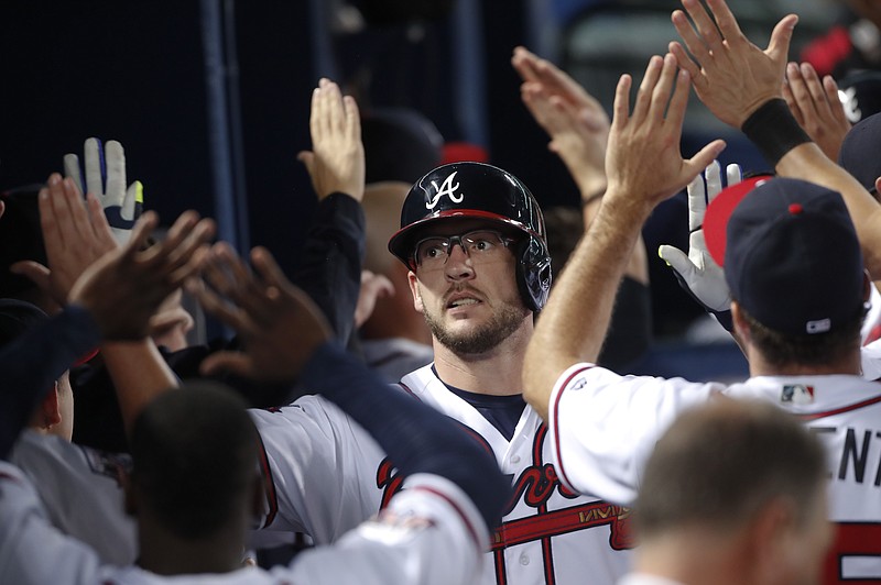 Atlanta Braves' Tyler Flowers celebrates in the dugout after hitting a three-run home run in the sixth inning of the Braves' baseball game against the Philadelphia Phillies on Tuesday, Sept. 27, 2016, in Atlanta. 