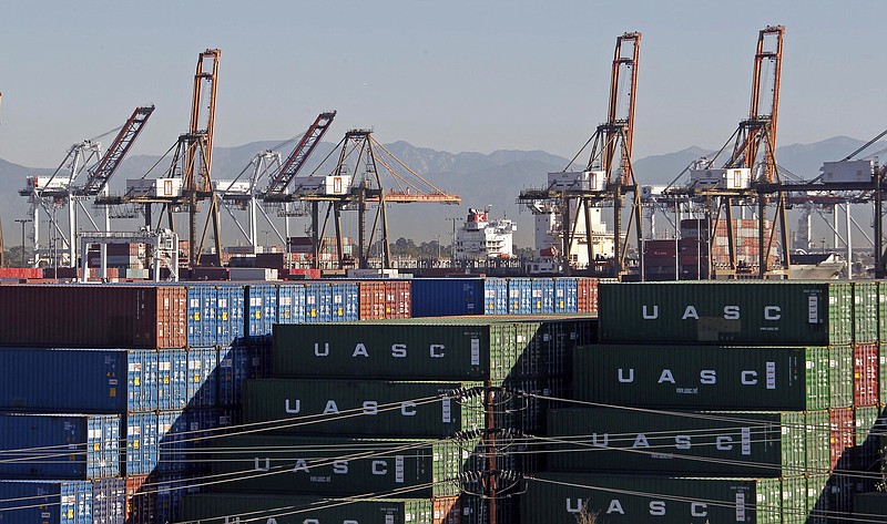 FILE - In this Feb. 12, 2015 file photo, the Port of Los Angeles, with some cargo loading cranes in the upright and idle position, are seen in this view from the San Pedro area of Los Angeles. In this angry election year, many American voters are skeptical about free trade, or hostile to it. The backlash threatens a pillar of U.S. policy: The United States has long sought global trade. Economists say imports cut prices for consumers and make the U.S. more efficient. (AP Photo/Nick Ut, File)