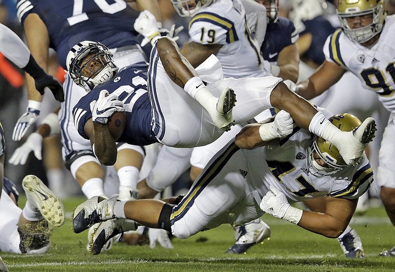 UCLA defensive lineman Eddie Vanderdoes, bottom, upends BYU running back Jamaal Williams during their game earlier this month in Provo, Utah. BYU (1-3) has had nothing but close games this season, with three points the largest margin of victory in any Cougars game.
