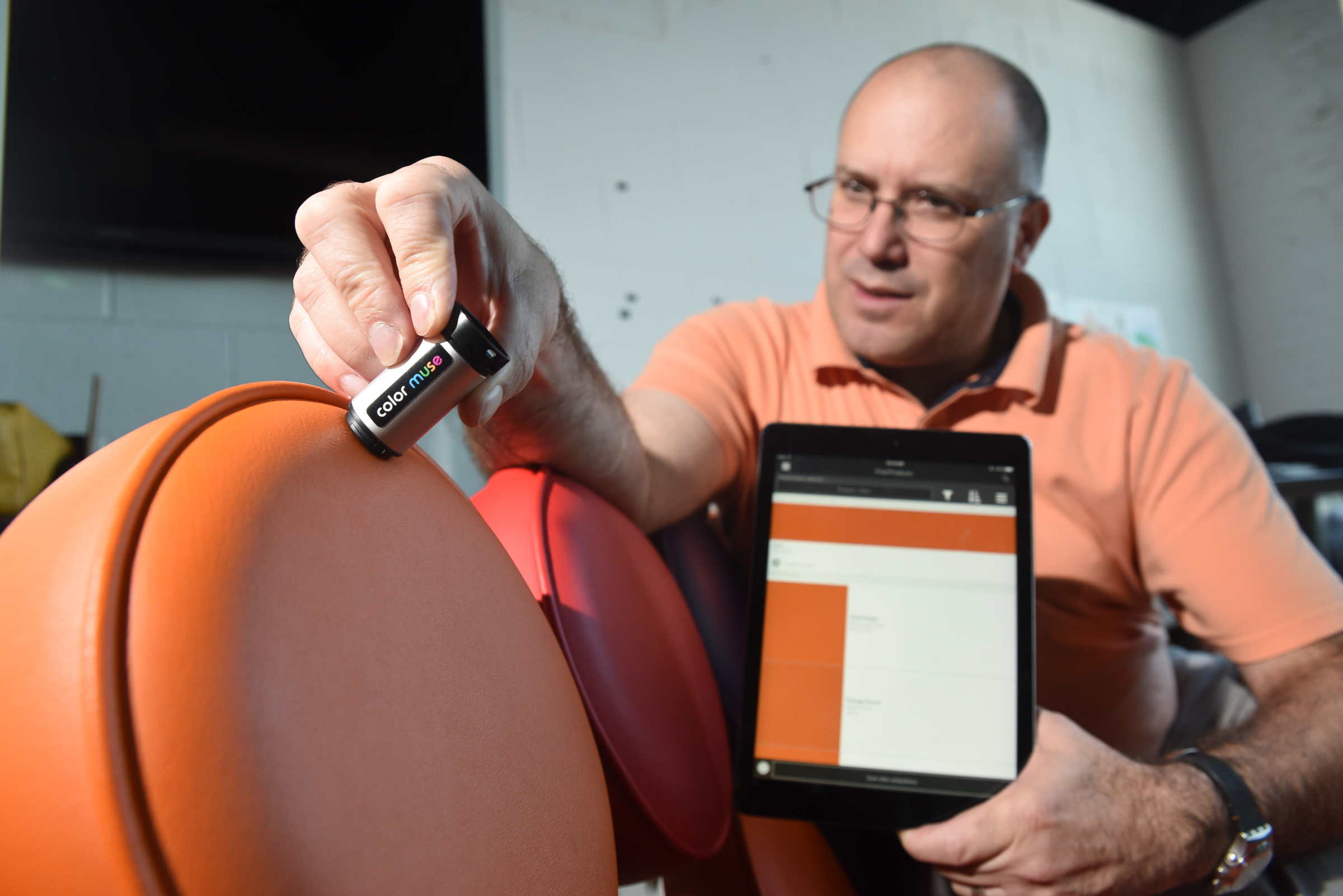 John Kowalski demonstrates the new ColorMuse unit that reads the exact color to match an existing color at the Variable, Inc. business in the incubator building on Cherokee Blvd.