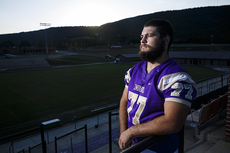 Sequatchie County football player John Higgins is photographed at the school's stadium Wednesday, Sept. 28, 2016, in Dunlap, Tenn. Higgins, a senior this year and a team leader, was adopted by a teammate's family after his mother struggled with drug addiction.