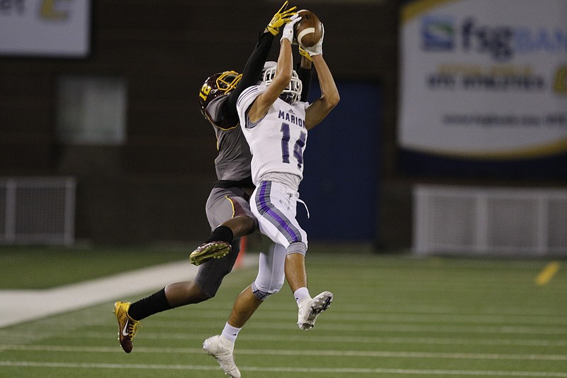 Marion County defensive back Nick Capps intercepts a pass intended for Tyner wide receiver Martavius Ryals during their prep football game at Finley Stadium on Thursday, Sept. 29, 2016, in Chattanooga, Tenn.