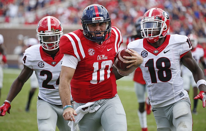 Georgia defensive backs Dominick Sanders (24) and Deandre Baker (18) give chase last Saturday on Ole Miss quarterback Chad Kelly's 41-yard touchdown run in Oxford, Miss. The Bulldogs lost 45-14, and it was the first time they've given up the first 45 points of a game in seven decades.