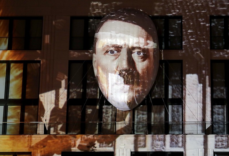 
              The face of Adolf Hitler is projected onto a 3D canvas as part of an art installation during a rehearsal for the 'Berlin Leuchtet' (Berlin shines) festival in Berlin, Germany, Thursday, Sept. 29, 2016. 'Berlin Leuchtet' takes place from Sept. 30 until Oct. 16, 2016 in the German capital. (AP Photo/Michael Sohn)
            