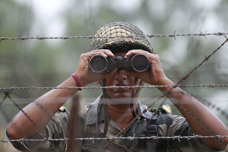 
              FILE - In this Sept. 24, 2016 file photo, an Indian Border Security Force soldier looks at the Pakistan side of the border through a binocular at Ranbir Singh Pura, about 35 kilometers (22 miles) from Jammu, India. In New Delhi, they say that highly trained Indian soldiers slipped across the de facto border and into Pakistani-controlled Kashmir in a daring nighttime raid, killing anti-India militants preparing to launch attacks. In Islamabad, they say that only one Indian soldier made it across the border, and he was captured, with Pakistani forces easily driving back the other Indians, who retreated as soon as they encountered resistance. The dueling tales of courageous forces serve politics on both sides of the border, with powerful forces in each country able to proclaim their courage in the face of aggression. (AP Photo/Channi Anand, File)
            