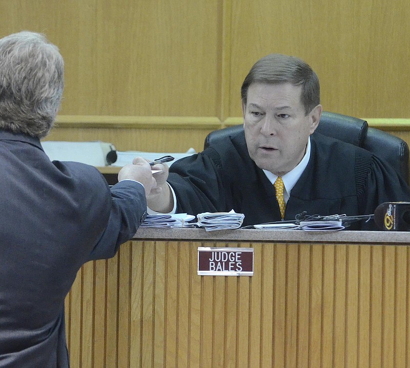 Judge David Bales confers with an attorney in this 2014 file photo.
