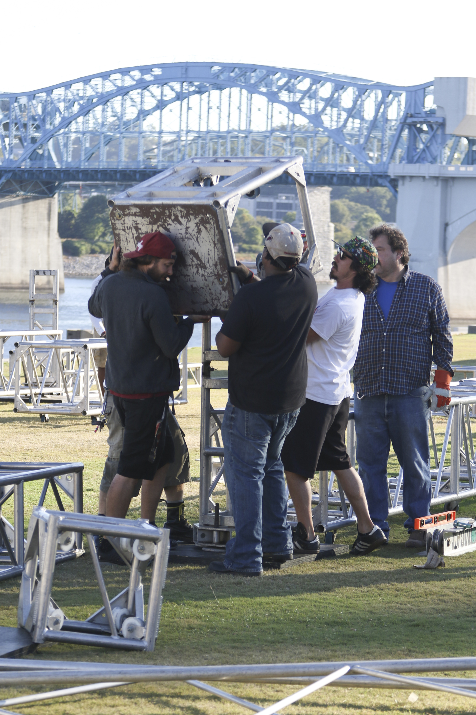Staff Photo by Dan Henry / The Chattanooga Times Free Press- 9/29/16. Workers with the American Stage Company, set up a 60'x20' stage on Thursday, September 29, 2016, along the riverfront in preparation for this weekend's 10th annual 3 Sisters Bluegrass Festival.